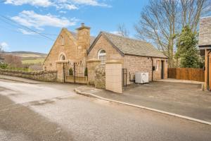 an old brick house with a fence and a street at 3 Bed in Dunning oc-t35973 in Dunning