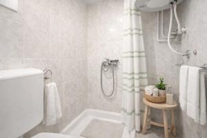 a bathroom with a shower and a toilet and a tub at Vila Kosta City Center Port in Ohrid +51 photos
