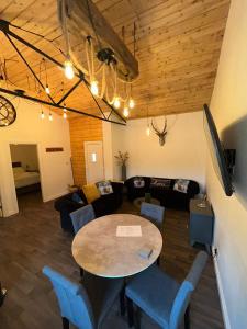 a living room with a table and a couch at The Stags Den in Longton