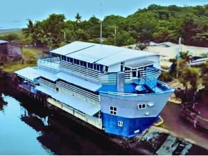 a large blue boat sitting in the water at Hotel Tagudan Kubo Corporation in Tagudin