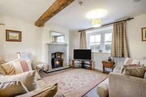 a living room with a fireplace and a tv at 4 Bed in Borrowby oc-o36892 in Borrowby