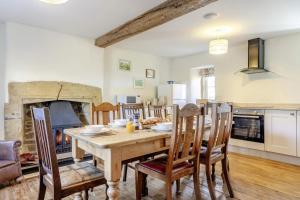 a kitchen and dining room with a table and a fireplace at 4 Bed in Borrowby oc-o36892 in Borrowby