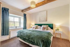a bedroom with a large bed and a window at 4 Bed in Borrowby oc-o36892 in Borrowby