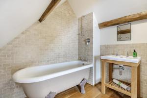 a bathroom with a white tub and a sink at 4 Bed in Borrowby oc-o36892 in Borrowby +31 photos