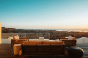 a living room with a couch and a view of the ocean at Jonesy's Place on the Beach in Yzerfontein