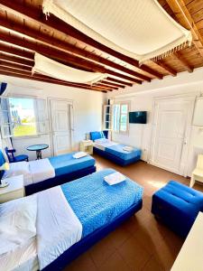 a room with three beds and a couch and a table at Anna in Megali Ammos