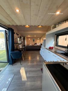 a living room with a couch and a table at Le Cabanon - Tiny House 150m de la Plage in Portbail