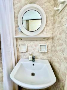 a bathroom with a white sink and a mirror at Anna in Megali Ammos +29 photos