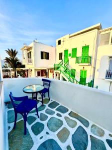 a patio with two chairs and a table on a balcony at Anna in Megali Ammos