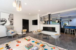 a living room with a couch and a fireplace at BW Plus Central Park Hotel & Spa in La Rochelle