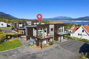 an aerial view of a house with a red marker at Nordic Comfort Suite with Hot Tub in Storeidet