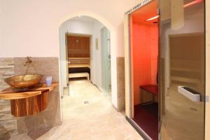 a bathroom with a sink and a room with a bed at Chalet Cristall Superior Appartement 9 in Leutasch