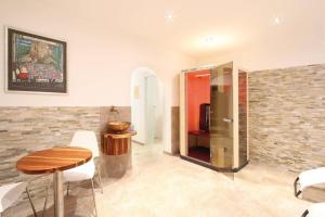 a dining room with a table and a refrigerator at Chalet Cristall Superior Appartement 9 in Leutasch +9 photos