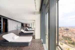 a balcony with couches and a view of a city at Eurostars Madrid Tower in Madrid