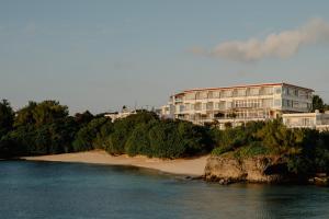 a building on a beach next to the water at Anse Yomitan Toya in Yomitan