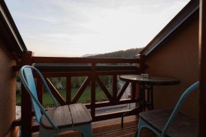 a balcony with a table and chairs and a view of a mountain at Hotel Green in Dolný Kubín