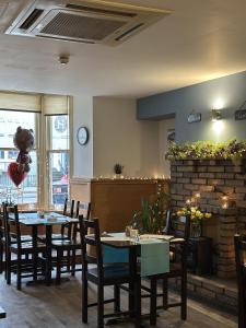 a dining room with tables and chairs in a restaurant at Harry's Hotel in Aberystwyth