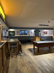 a room with a pool table and a bar at Harry's Hotel in Aberystwyth