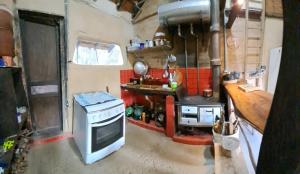 a small kitchen with a stove and a sink at Caminho das Montanhas eco in Itanhandu +21 photos