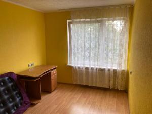 an empty room with a desk and a window at Apiņa 18 in Valmiera +1 photo