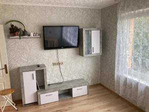 a living room with a tv on the wall at Apiņa 18 in Valmiera