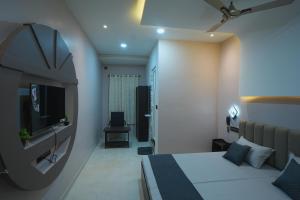a hotel room with a bed and a mirror at Kasa Courtyard Hotel in Begusarai