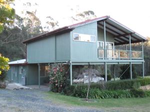 a house on the side of a road at Bournda Retreat in Merimbula