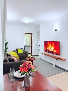a living room with a couch and a fireplace at Lumora Homes in Arusha