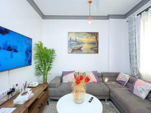 a living room with a couch and a table at Cosy 1 Bedroom in CBD Mombasa with City View in Mombasa