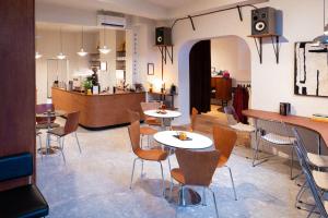 a restaurant with tables and chairs and a counter at ROMY ANTWERP Sint-Jansvliet in Antwerp