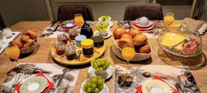 a table with breakfast foods and drinks on it at Au Fond des Rys in Grez-Doiceau +23 photos