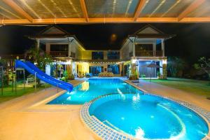 a large swimming pool with a slide in a house at villa Tip in Ban Na An
