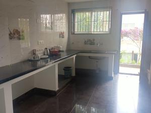 a kitchen with a counter and a sink in it at Misty Hills in Yercaud