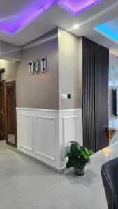 a lobby with a clock on the wall and a plant at vale mombasa nyali in Mombasa +8 photos