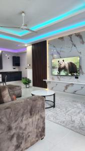 a living room with a bear on the screen at vale mombasa nyali in Mombasa