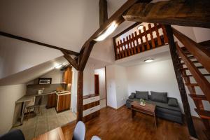 a living room with a couch and a table at Penzion U Holuba in Hradčovice