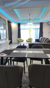 a room with couches and tables and chairs at vale mombasa nyali in Mombasa