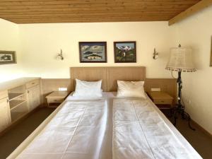 a bedroom with a large white bed with two pillows at Chalet Cristall Superior Appartement 2 in Leutasch