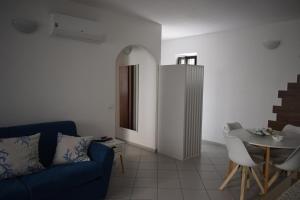 a living room with a blue couch and a table at Il Borgo civ 25 in Paola