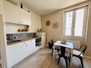 a kitchen with a table and a small table and chairs at Le Petit Boursiers - hyper centre in Castres