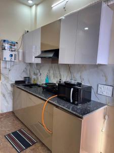 a kitchen with a microwave on top of a counter at Harmony House in Ghaziabad +1 photo
