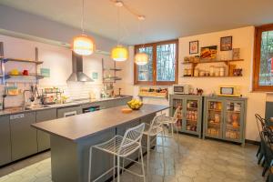 a kitchen with a large island with bar stools at Ostello Bello Milano Duomo in Milan