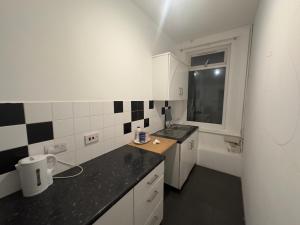a small kitchen with a sink and a tub at The Dharma Lodge in Enfield +70 photos