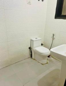 a bathroom with a toilet and a sink at Kunal Homestay in Rāmghāt