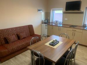 a living room with a couch and a table at Apartmány Vinařství Tesařík in Prušánky