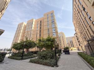a large building with trees in front of it at Golden Sunset Luxe 1BR CB2-3-RA1-812-1br in Sabkhah