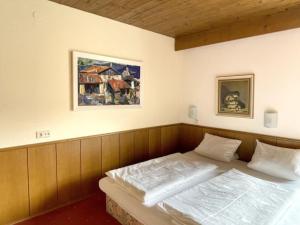 a bedroom with a bed and a painting on the wall at Chalet Cristall Superior Appartement 1 in Leutasch