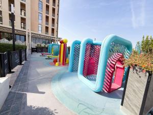 a playground in a city with a roller coaster at Golden Sunset Luxe 1BR CB2-3-RA1-812-1br in Sabkhah