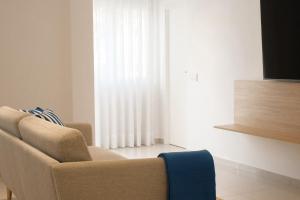 a living room with a couch and a window at Nila 1 by Huskalia in Los Llanos de Aridane +15 photos