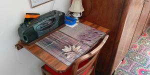 a small wooden table with a lamp on top of it at Room for you in Warsaw
